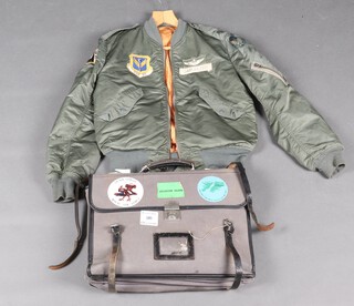 A USAF Type L-2B M1-A bomber jacket, an RAF Air Crew navigator/pilots bag containing and A-N US Navy Rude star indicator type 1, 3 pilots dead reckoning computers, a Douglas combined protractor etc 