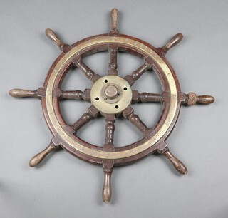 A mahogany and brass 8 spoked ships wheel 77cm 