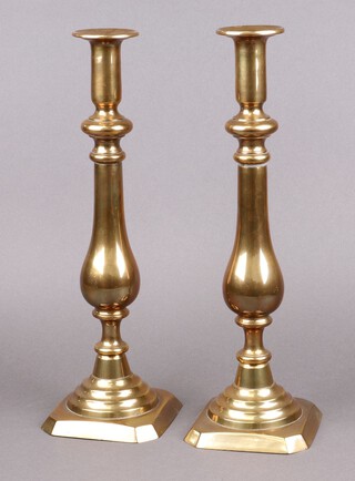 A pair of 19th Century brass candlesticks with ejectors 41cm 