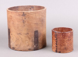 A Victorian 168 cylindrical wooden grain measure 10cm (signs of old but treated worm) together with a George V London County Council gallon measure marked 18, 19cm 
