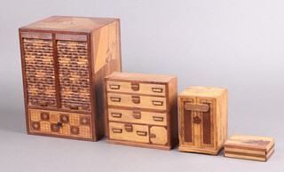 A Japanese box with 2 sections and tambour shutter, the base fitted a drawer 24cm high x 17cm w x 16cm d, a puzzle box in the form of a cabinet 12cm x 8cm x 8cm, a 1 other decorated a volcano 9cm x 6cm 