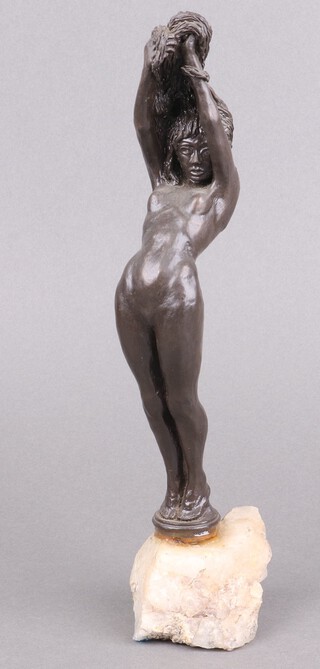 A bronze figure of a standing naked girl on a rocky outcrop 29cm, base has been glued 