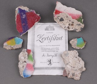 A collection of small sections of The Berlin Wall together with certificate 