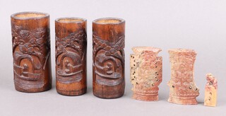 A carved soapstone seal decorated Dog of Fo 6cm, 2 shaped pierced soap stone vases 10cm (chips in places) and 3 carved bamboo brush pots decorated figures 15cm 