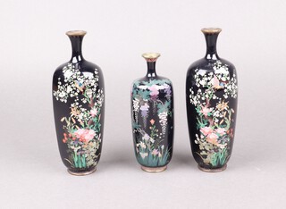 A pair of Japanese hexagonal black ground cloisonne enamelled vases decorated birds amongst branches 18cm, together with 1 other with floral decoration 16cm 