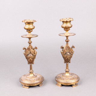 A pair of 19th Century ormolu candlesticks with griffins, raised on panelled supports with detachable sconces 23cm 