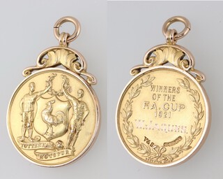 A Tottenham Hotspurs 1921 FA Cup Winners medal in 15k gold awarded to reserve goal keeper William Jaques.

The obverse with Spurs motif, the reverse engraved "WINNERS OF THE F.A. CUP 1921 W JAQUES" within a wreath together with Birmingham hallmarks and makers mark V&S ( Vaughton and Sons )

The 1921 FA Cup final was held between Tottenham Hotspur and Wolverhampton Wanderers with Spurs winning 1-0.

Please note:  a gold pocket watch presented to him by the Directors of Tottenham Hotspur FC is lot 558 and 2 other football medals presented to him are lot 741