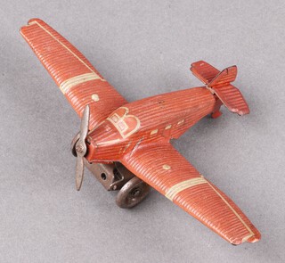 A 1930's clockwork tin plate aeroplane, the base marked German D.R.G.M (likely Technofix) 14cm w x 9cm d 