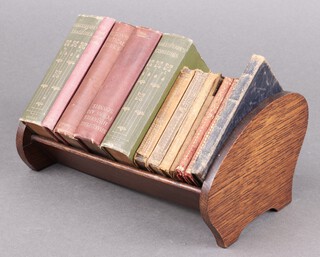 A collection of miniature volumes in a fitted oak book trough to include Shakespeare's Tragedies, The Oxford Books of Carols, Milton's Poetical Works, Shakespeare's Histories, Poems and Sonnets, Shakespeare's Comedies, Days of Ancient Rome, etc 