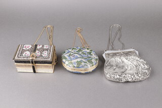 Judith Leiber, a lady's clutch bag in the form of 3 books 13cm x 8cm x 6cm with purse and a ditto oval clutch bag 10cm x 4cm x 6cm containing a gilt metal hand mirror, both with outer cloth bags, together with a Glomesh silver coloured evening bag 