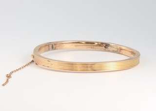 A gold marked 15ct bangle, 6.5cm w, 9g