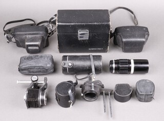 An Olympus Pen F T Half Frame Camera, serial no 160032, in associated Olympus shaped leather hard case, shutter working, with F Zuiko 38mm f/1,8 lens, no. 126741, an Olympus Pen-F 35mm Half frame camera with Zuiko Auto-S 40mm F/1.4 lens, no.144808, an Olympus Pen EED camera with F Zuiko 32mm f/1.7 lens, an Olympus E Zuiko Auto-W 25mm 1:4 lens (cased) together with several lenses and accessories