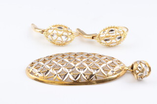 A two colour gold marked 750 pendant 5cm, together with a matching pair of earrings, gross weight 7.1g