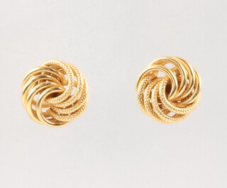 A pair of gold marked 750 knot ear studs 1.5g together with a pair of gold marked 9ct screw clip ear mounts 0.6g