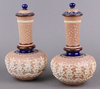 A pair of Doulton Lambeth salt glazed club shaped urns and covers, bases impressed Doulton Lambeth incised MA for Mary Aitken 25cm  