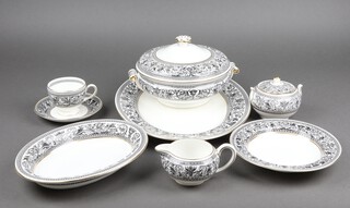A 78 piece Wedgwood Florentine pattern dinner service comprising twin handled soup tureen, oval meat plate, 3 oval dishes, 14 dinner plates, 12 soup bowls, sauce boat and stand (chip to stand), 12 side plates, bread plate, 12 tea plates, coffee pot, teapot, lidded sugar bowl and cream jug, 8 cups, 9 saucers (1 rings flat) 