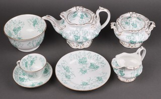 A 29 piece G W Mossfield green glazed leaf pattern tea service comprising teapot, 2 twin handled bread plates, slop bowl, cream jug, lidded sugar bowl, tea plate and 11 cups and 11 saucers