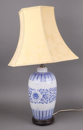 A blue and white porcelain table lamp in the form of a Chinese urn raised on a hardwood base 37cm  