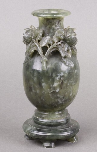 A Chinese spinach jade vase with floral decoration on a circular base 19cm 