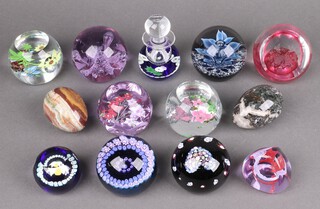 Nine Caithness paperweights with certificates - Heart, Amethyst Bouquet, Autumn Bouquet, Blue Floral Fountain, Flutterby, Amethyst Lace, Moon Flower, Pebble and Miniature Narcissus, a Caithness perfume thistle bottle with certificate, a 40th Anniversary paperweight and 2 carved stone eggs 