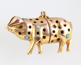 A yellow metal 2 section pendant/charm in the form of a pig set turquoise (some missing), 3.5cm, 3.3g