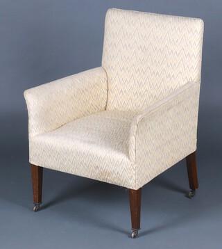 An Edwardian mahogany armchair upholstered in white material 