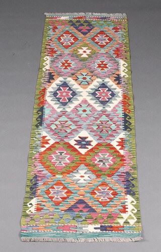 A white, turquoise, green and purple ground Chobi Kilim runner with overall geometric designs 194cm x 63cm 