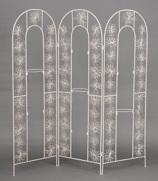 A wrought metal 3 fold screen, the centre fitted plant holders 161cm h x 158cm w 
