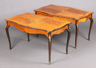A pair of French Kingwood coffee tables of serpentine outline, raised on cabriole supports 52cm h x 99cm w x 60cm d (damage to veneer in places)
