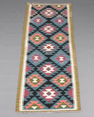 A black, blue, green and white ground Maimana Kilim runner with all over diamond design 190cm x 71cm 