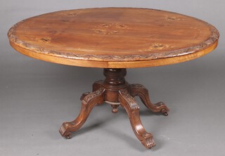 A Victorian quarter veneered carved and inlaid walnut Loo table, raised on a turned column with tripod base 70cm h x 129cm w x 99cm d 