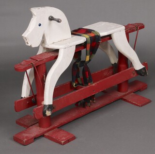 A child's red and white painted rocking horse on a cruciform base 63cm h x 95cm w x 41cm d  