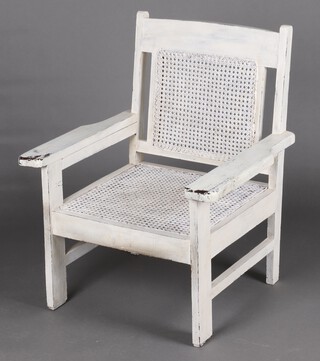 A white painted hardwood open arm chair with woven cane seat and back 