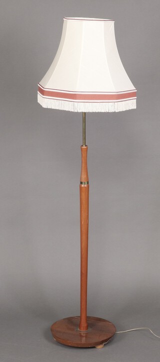 A mid-century teak standard lamp on a circular base (a/f) 111cm h 
