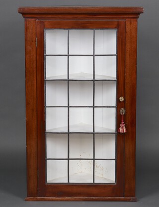 An Edwardian mahogany corner cabinet enclosed by a lead glazed panelled door 124cm h x 77cm w x 54cm d 