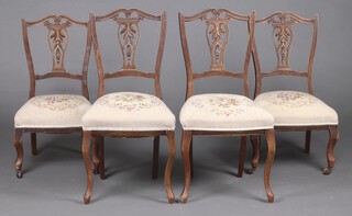 Two pairs of late Victorian bleached and pierced beech dining chairs with vase shaped slat backs and over stuffed seats, with matching upholstery, raised on cabriole supports (one pair cut down) 