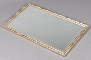 A rectangular bevelled plate mirror contained in a decorative gilt frame 46cm x 81cm 