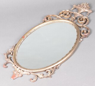 A 19th Century style oval plate mirror contained in a gilt resin frame surmounted by an urn 106cm x 47cm 
