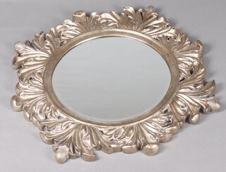 A circular bevelled plate mirror contained in a gilt resin frame 77cm diam. 