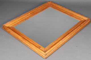 A rectangular plate mirror contained in a cushion effect pine frame 50cm x 102cm 