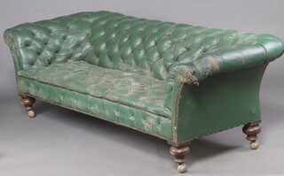 A Victorian Chesterfield upholstered in green buttoned leather (in barn condition, damaged to one end) 