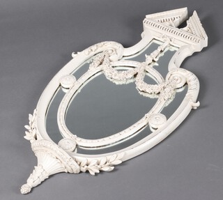 A reproduction Victorian shield shaped mirror contained in a carved wood and resin frame with floral swags 103cm h x 59cm w  