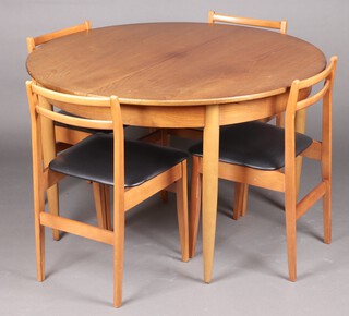A mid-century teak dining suite comprising circular extending dining table raised on turned supports 72cm h x 110cm diam. and a set of 4 ladder back dining chairs 