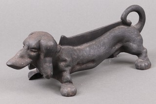 A cast iron boot scraper in the form of a Dachshund 13cm h x 37cm w