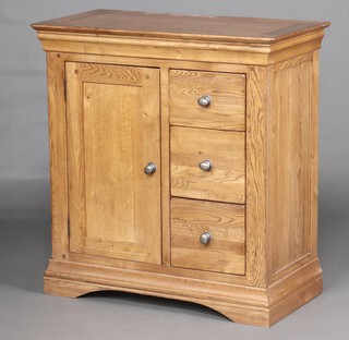 A rectangular oak cabinet, fitted cupboard enclosed by a panelled door flanked by 3 drawers, raised on bracket feet 91cm h x 87cm w x 44cm d 