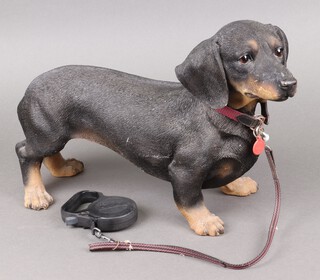 A resin figure of a standing Dachshund 30cm h x 45cm l
