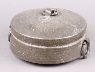 An Easter circular planished metal twin handled box and cover with ring drop handles 8cm x 20cm 