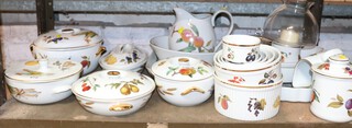 A collection of Worcester Evesham Gold pattern dinner ware comprising lemonade jug, 5 tureens and covers, 2 flan dishes, 6 dishes, square dish, 2 oval dishes, table lantern with glass shade, egg coddler, jar and cover and a jug 