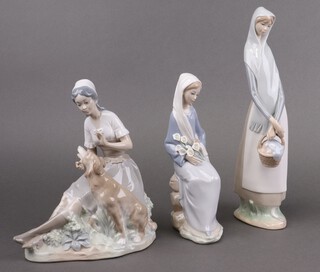 A Lladro porcelain figure, Girl with Basket 4501, 32cm, ditto Girl with Lillies Sitting 4972 22cm and a Nao figure of a girl with seated dog 21cm 
