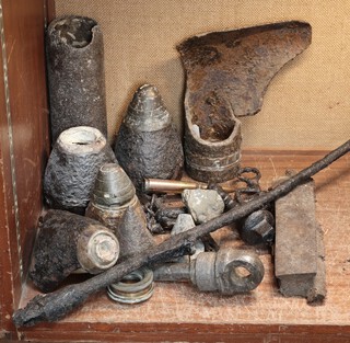 A large section of shrapnel, various recovered shell nose cones etc 